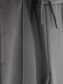 Calças Treino Cordão Corte Perna Larga